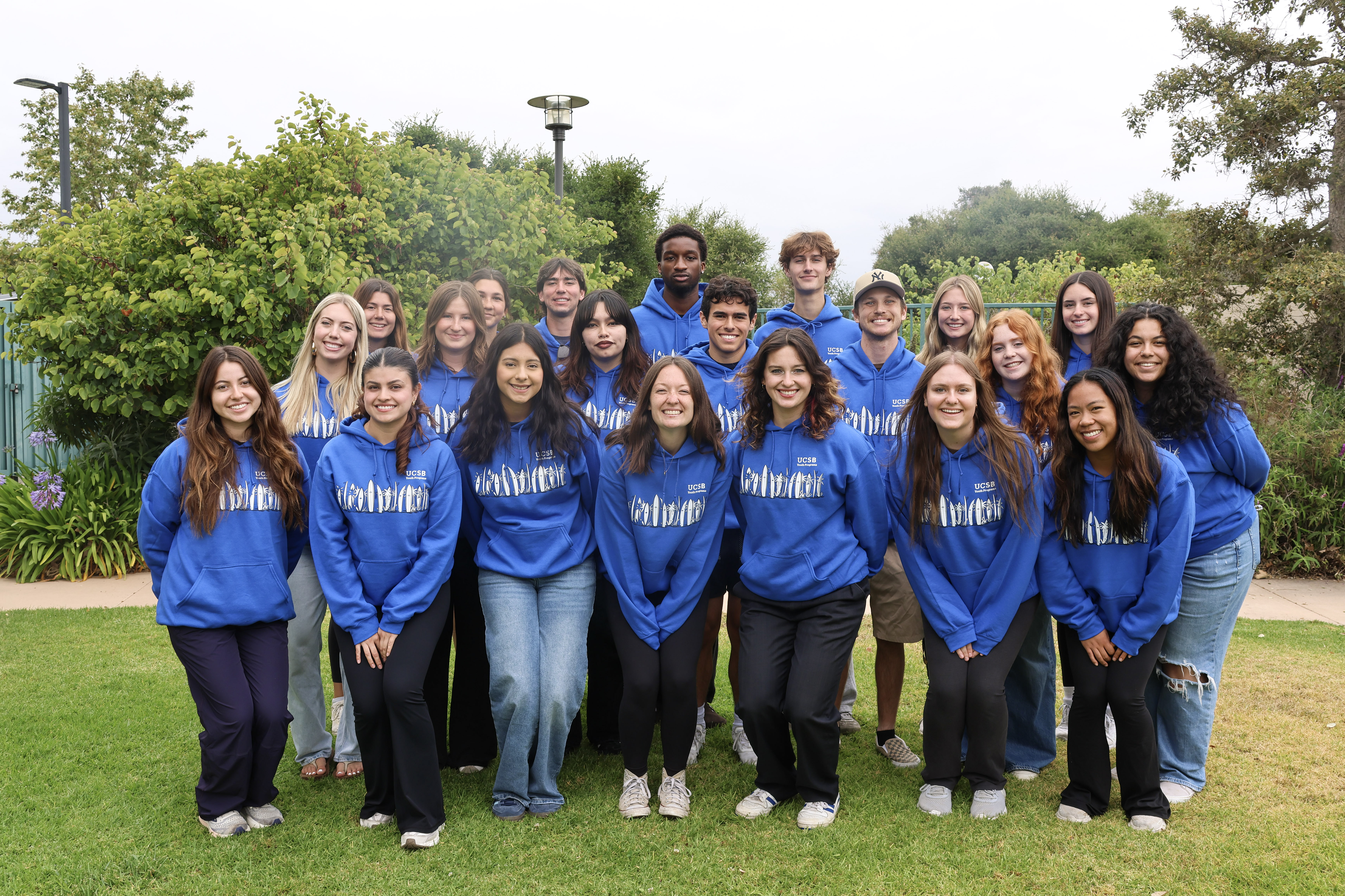 Group photo of 2026 Summer Day Camp Counselors wearing blue hoodies.