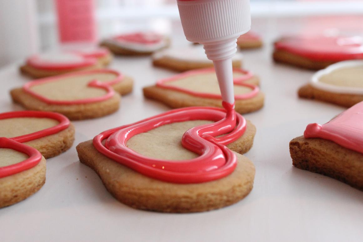 Heart shaped cookie being iced